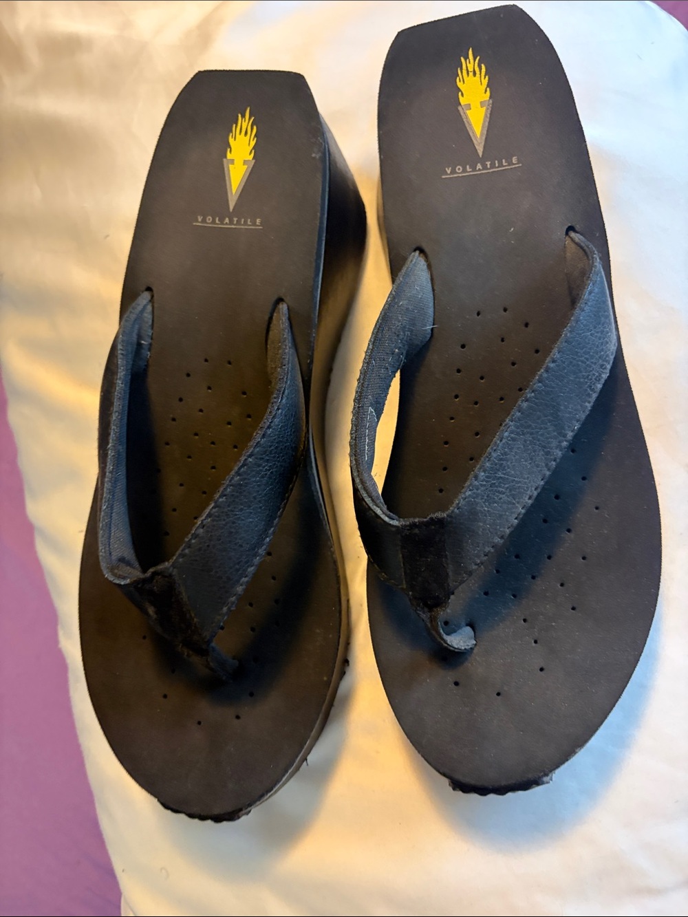 Volatile Black Platform Flip Flop Sandals with Yellow Logo
